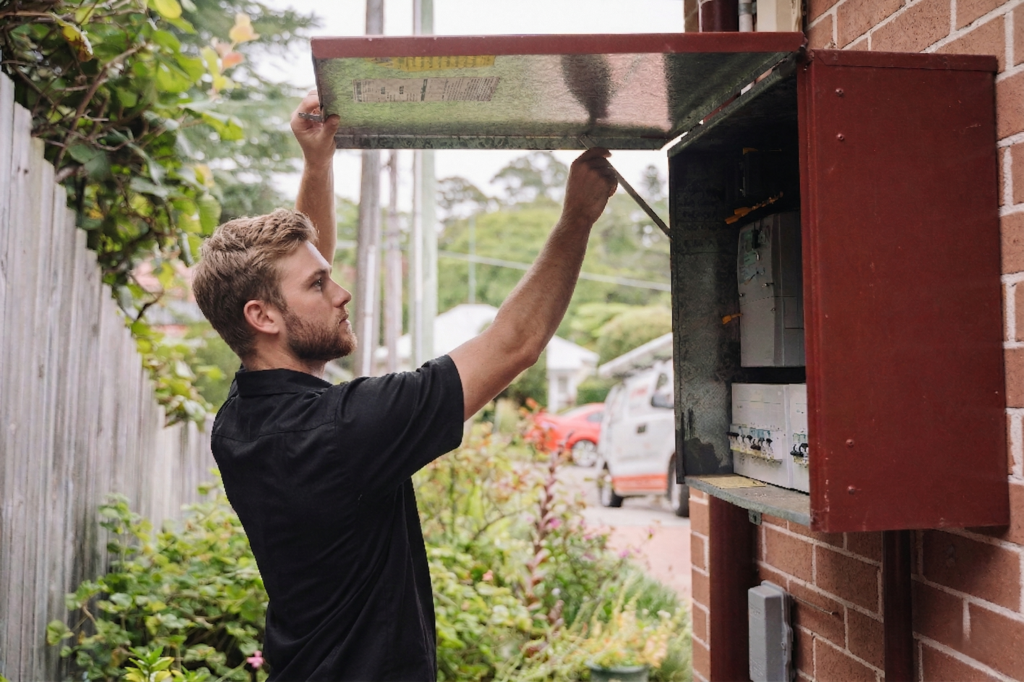 Electrician installing downlights in a Haymarket home